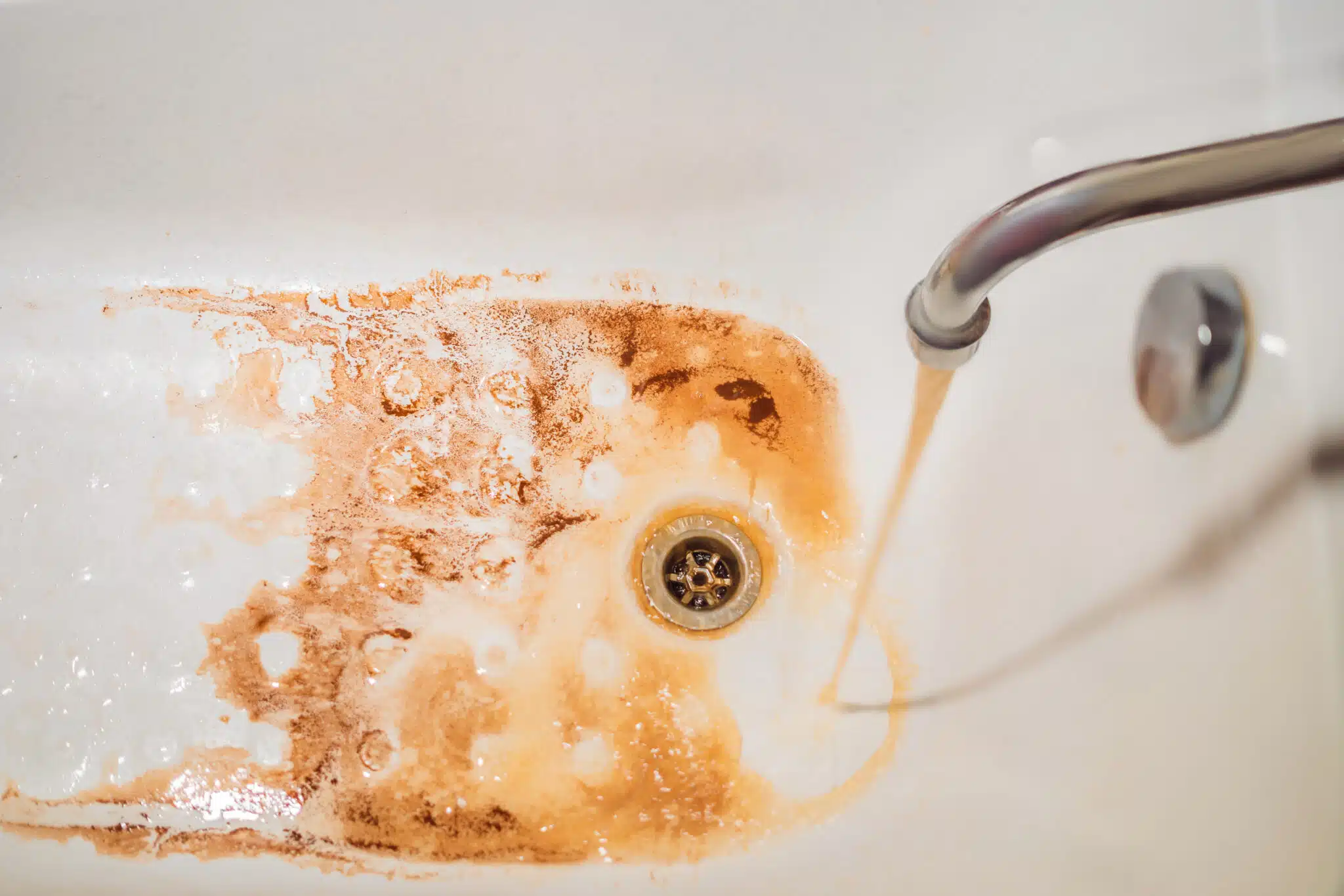 Discolored water is a sign that you need backflow prevention services.