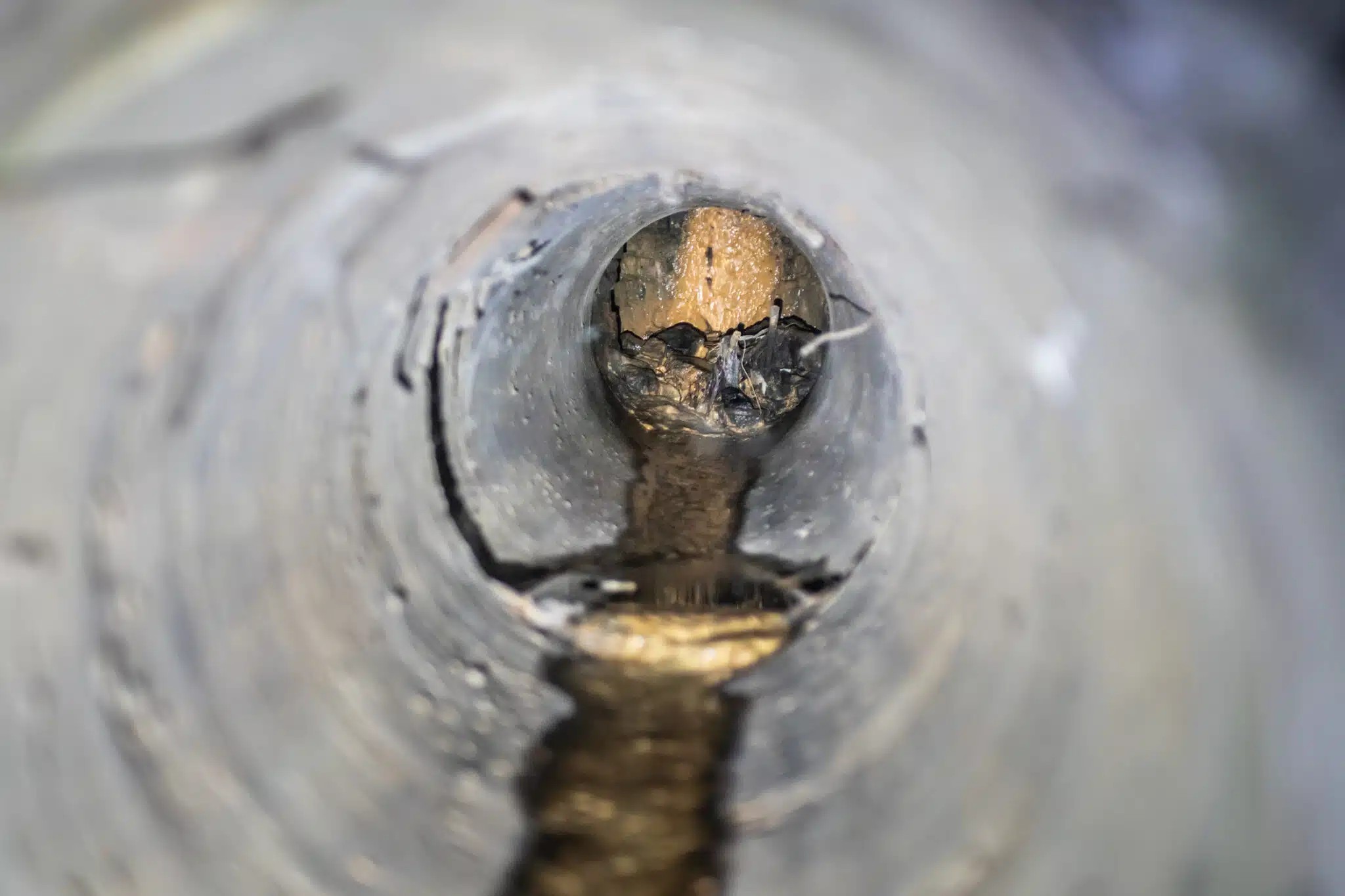 Inside a narrow concrete sewer pipe with Hydro Jetting.