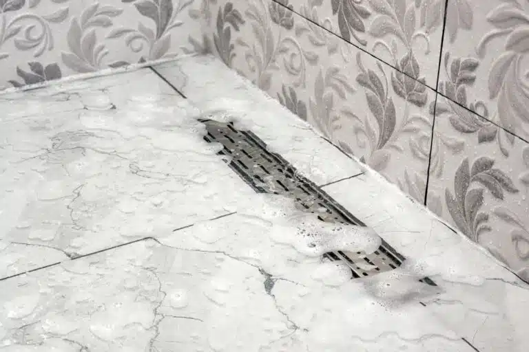 Signs You Need Professional Drainage Solutions, Water foam does not drain in the shower stall bathroom.