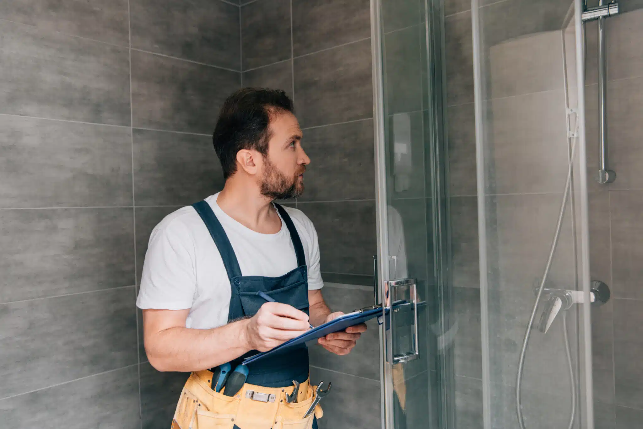 Checking shower in bathroom, Professional Plumbing Inspection.